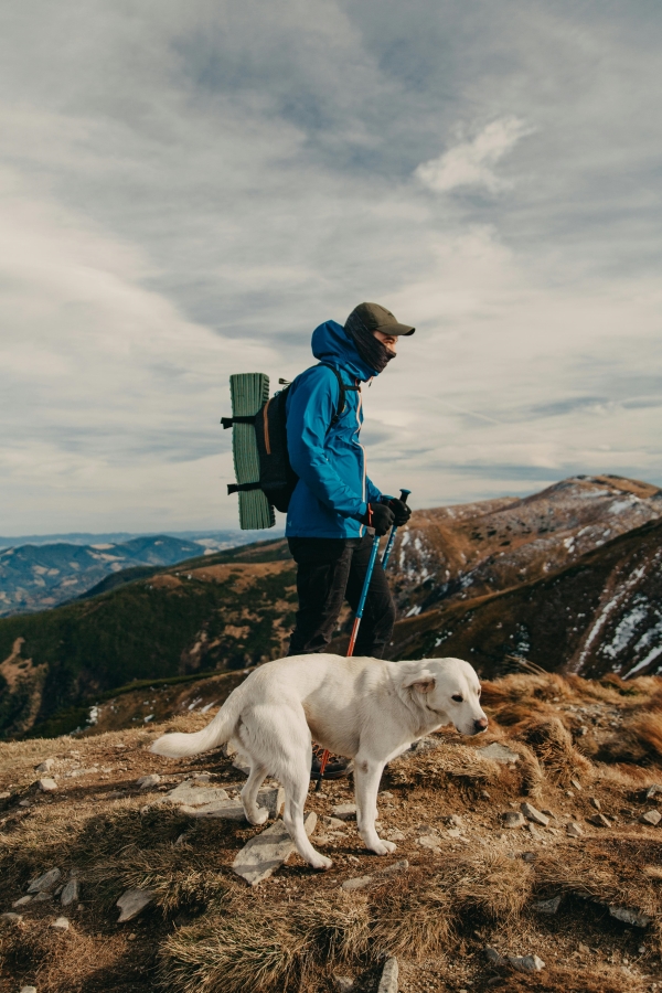 A man walking his god on a mountain